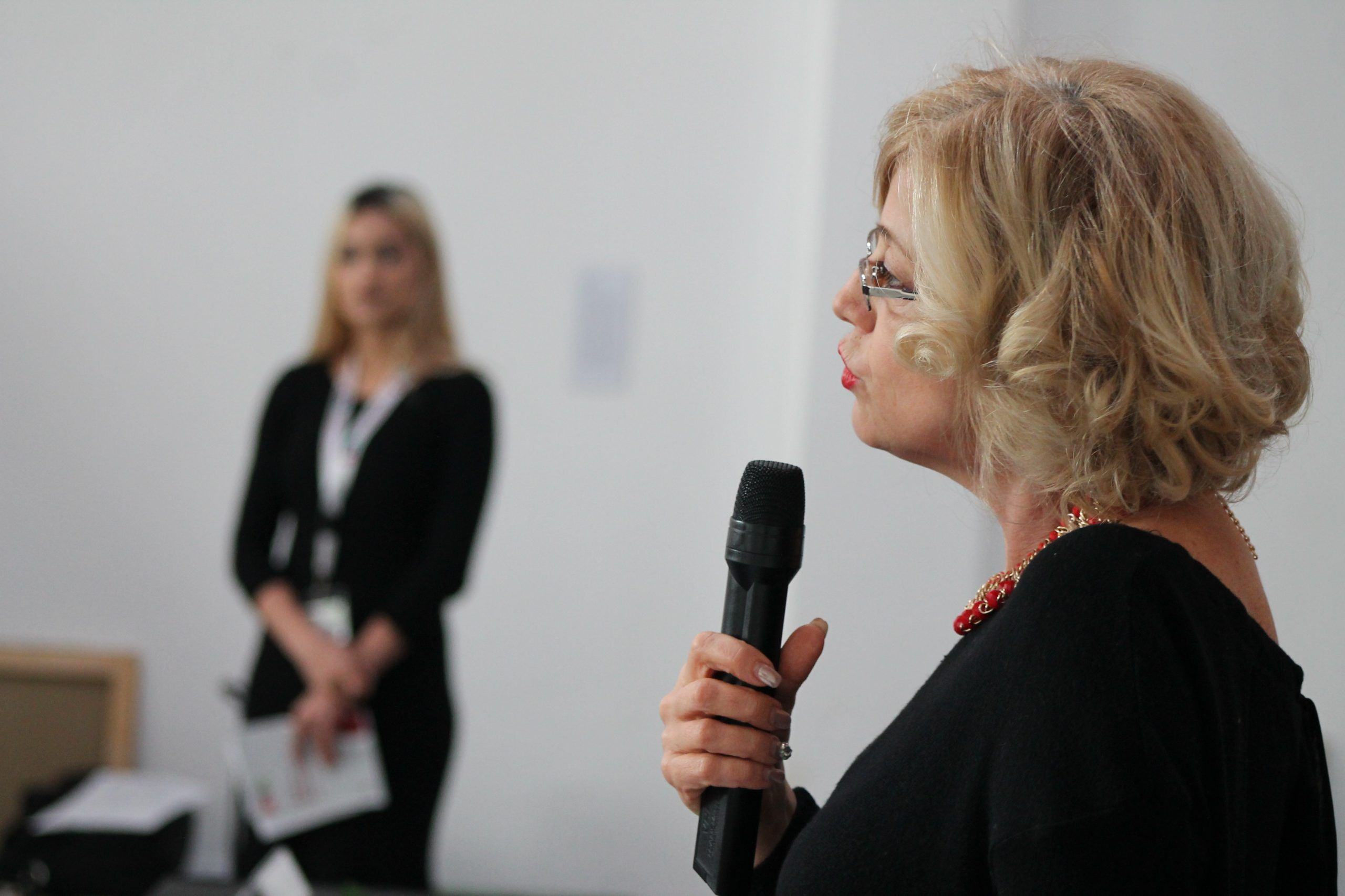 A speaker addressing participants with a microphone at an RVA event