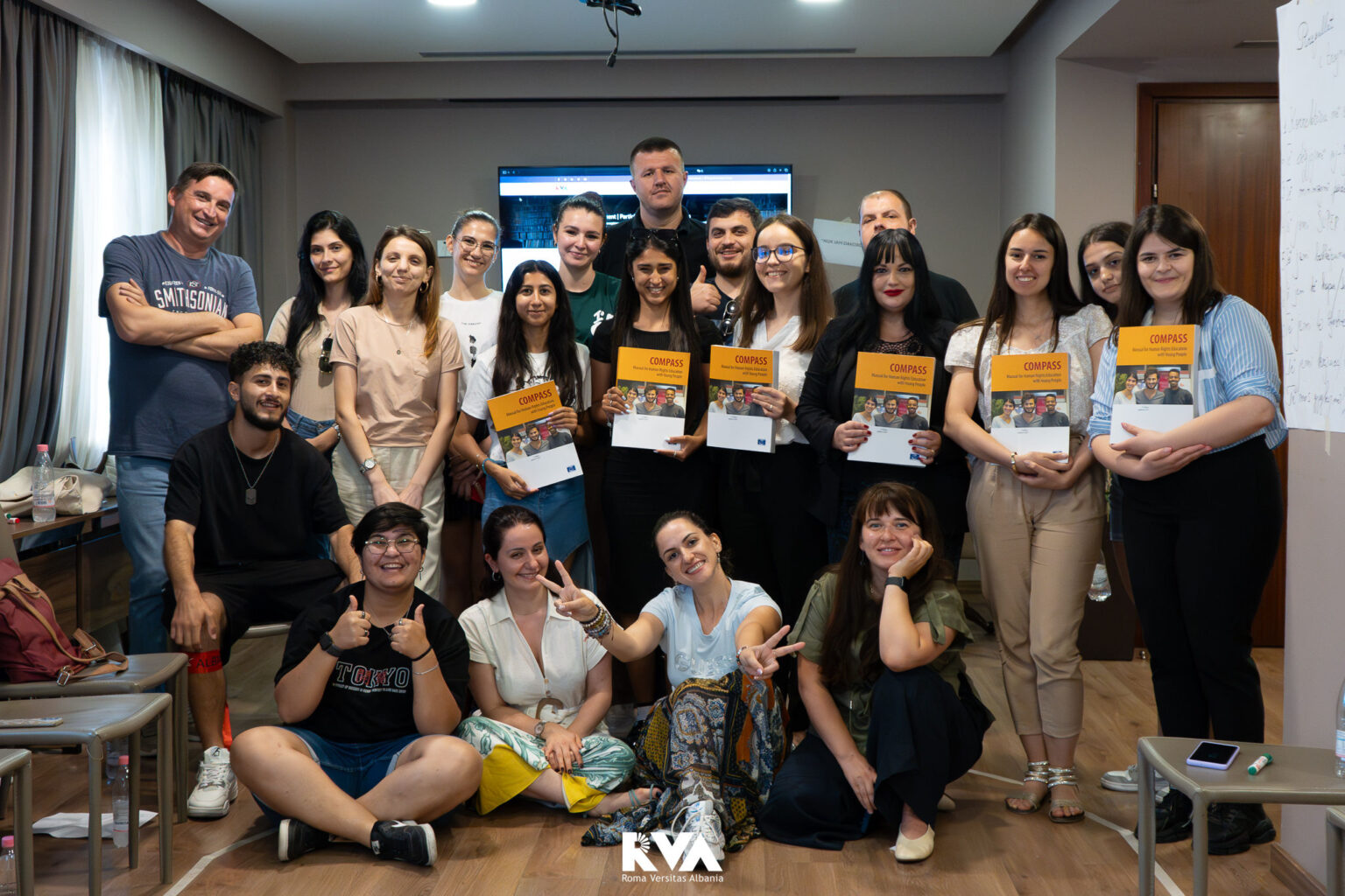 Participants holding their Compass manuals at the close of the human rights education training in Tirana