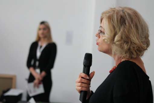 A speaker addressing participants with a microphone at an RVA event