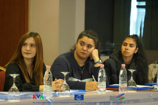 Three students taking notes during a session of the school financed by the Council of Europe